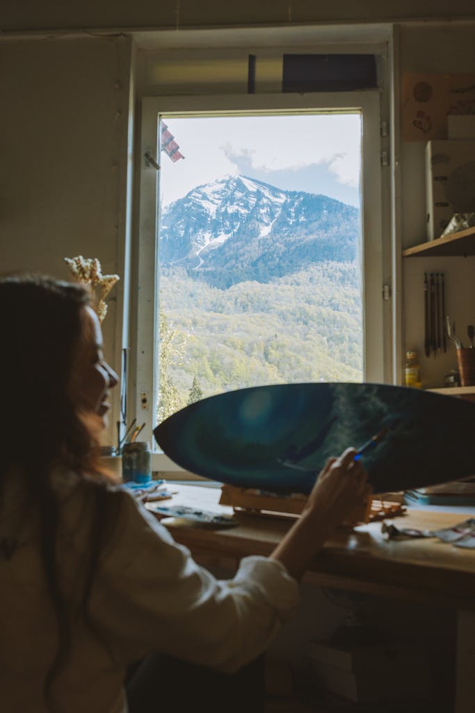 Photo of a Happy Woman Painting