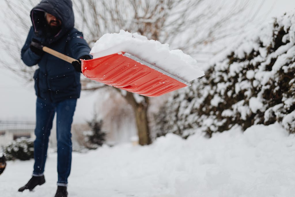 A Man Using a Shovel to Remove Snow