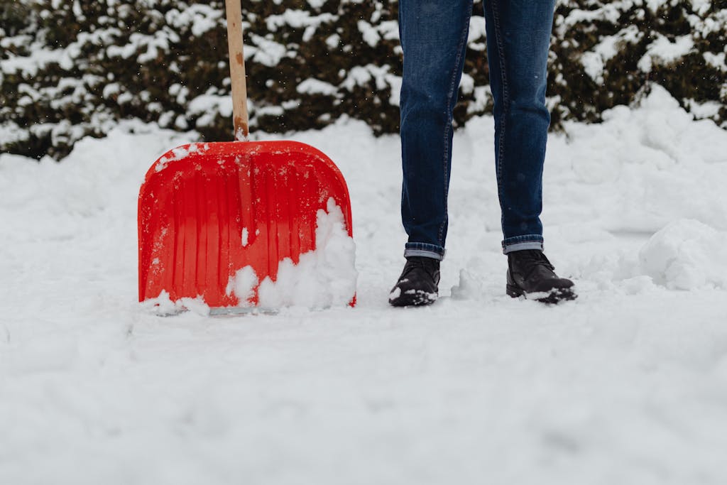 Man Plowing with a Red Snow Shovel